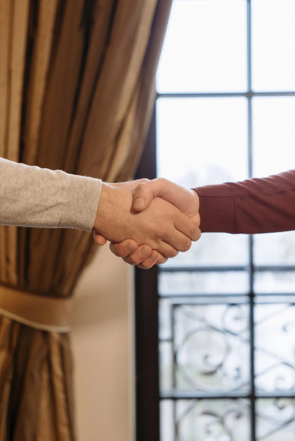Handshake by a bright window sealing an agreement